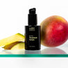 Return Treatment Serum with bottle and mango on glass shelf