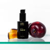 Retreat Facial Oil with bottle and plums on a glass shelf